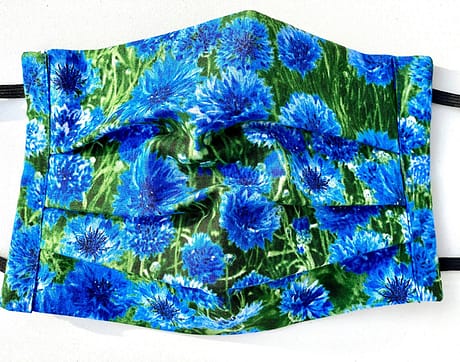 Cornflower Meadow Mask Closeup | closeup of fabric with grass background with realistic images of cornflowers