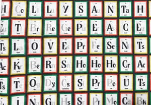 White fabric with periodic table style pattern containing elements spelling out Christmas themed words