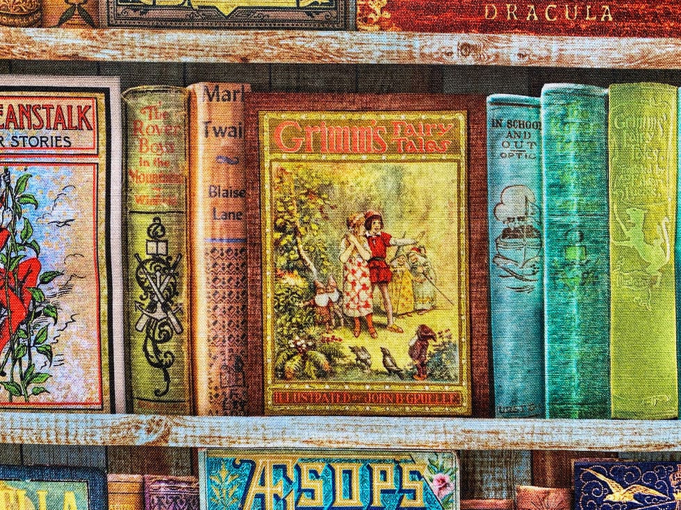 Classic Childrens' Books Fabric Closeup | Shelves of childrens' books centred on Grimm's Fairy Tales cover 