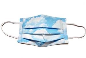 Longshot of mask with light blue fabric with fluffy white clouds