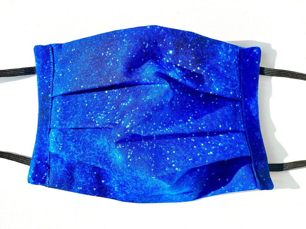 Starry Night Mask Closeup | closeup dark blue fabric with illustrated stars and lighter blues variation