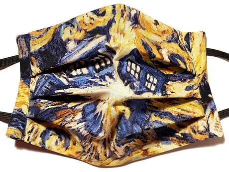 Navy and gold coloured fabric mask with swirls of the Tardis from Dr Who exploding