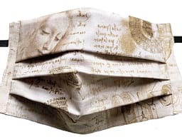 Parchment style fabric mask with DaVinci's handwriting notes on his inventions with drawings