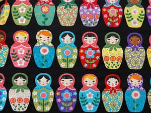 Black fabric with multicoloured pattern of Matryoshka dolls