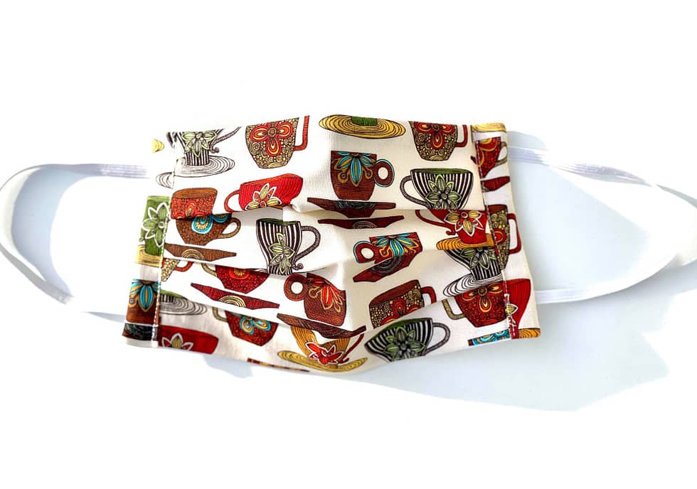 Teacups Mask | cream fabric with multicoloured teacups and saucers design