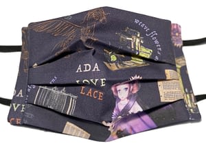 Ada Lovelace original design fabric mask with cartoon image of Ada plus her steam powered horse-plane and the Jacquard loom and Analytical Engine with quotes from her poetry and flowers and leaves made of her equations