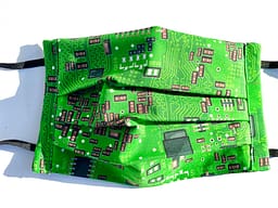 Circuit Board Mask Closeup | closeup of bright green fabric with illustrations of a circuit board in black white and grey