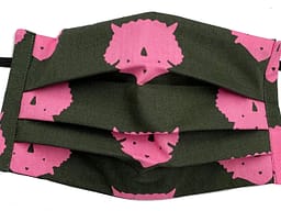 Dark grey fabric with silhouette print of pink triceratops heads mask closeup